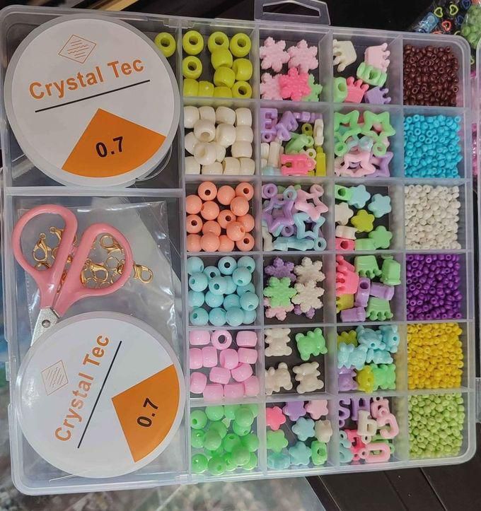 A Box Of Beads For Girls In Different Shapes And Colors To Make Accessories