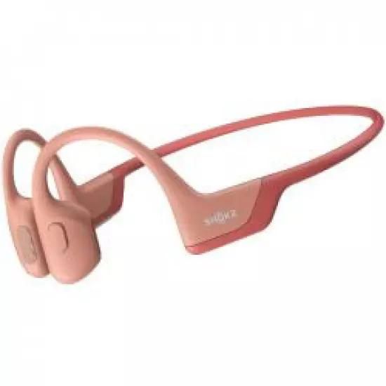 Shokz OpenRun PRO Bluetooth headphones in front of ears, pink | Gear-up.me