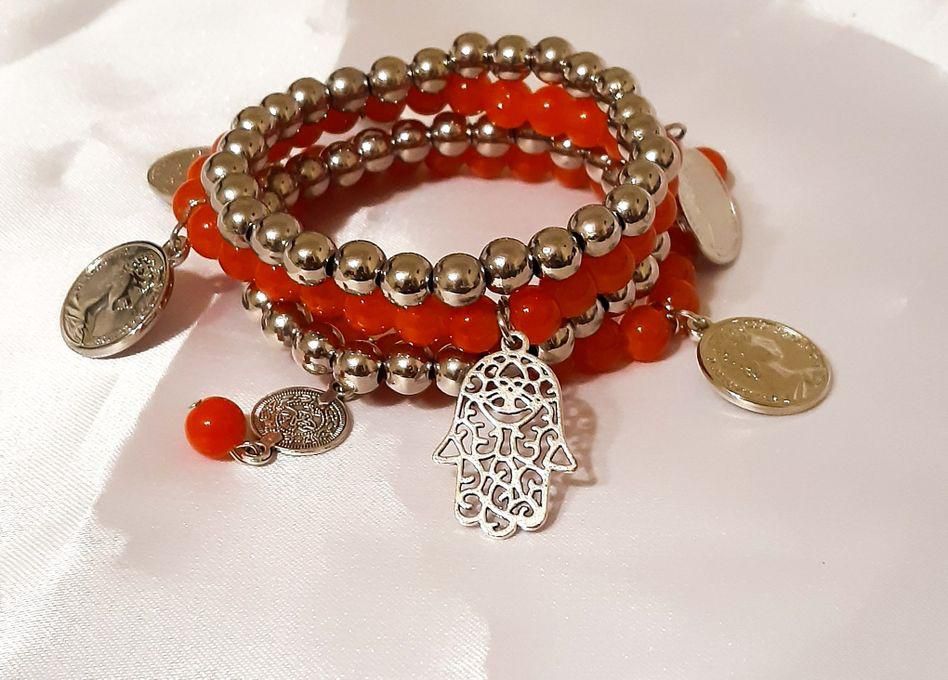 A Beautiful Layered Bracelet Of Silver And Orange Beads With Pandents