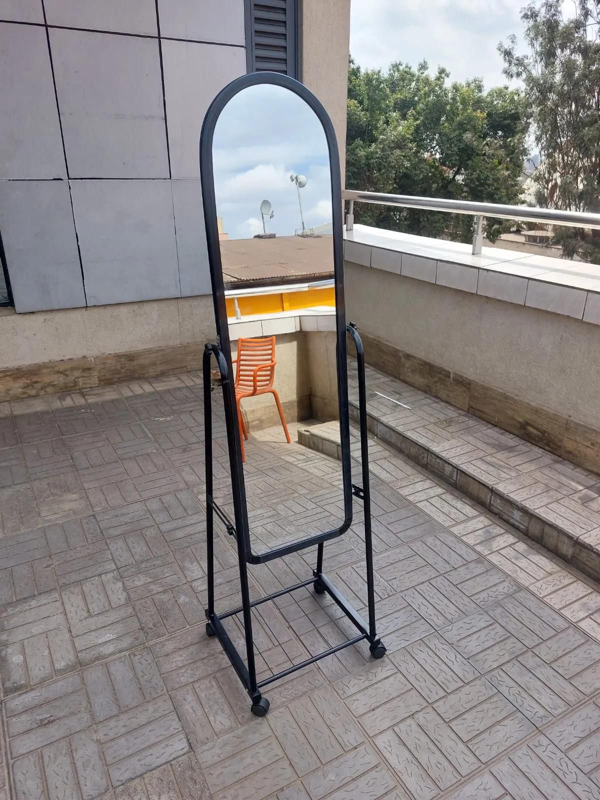 Full length portable dressing mirror with wheels.
