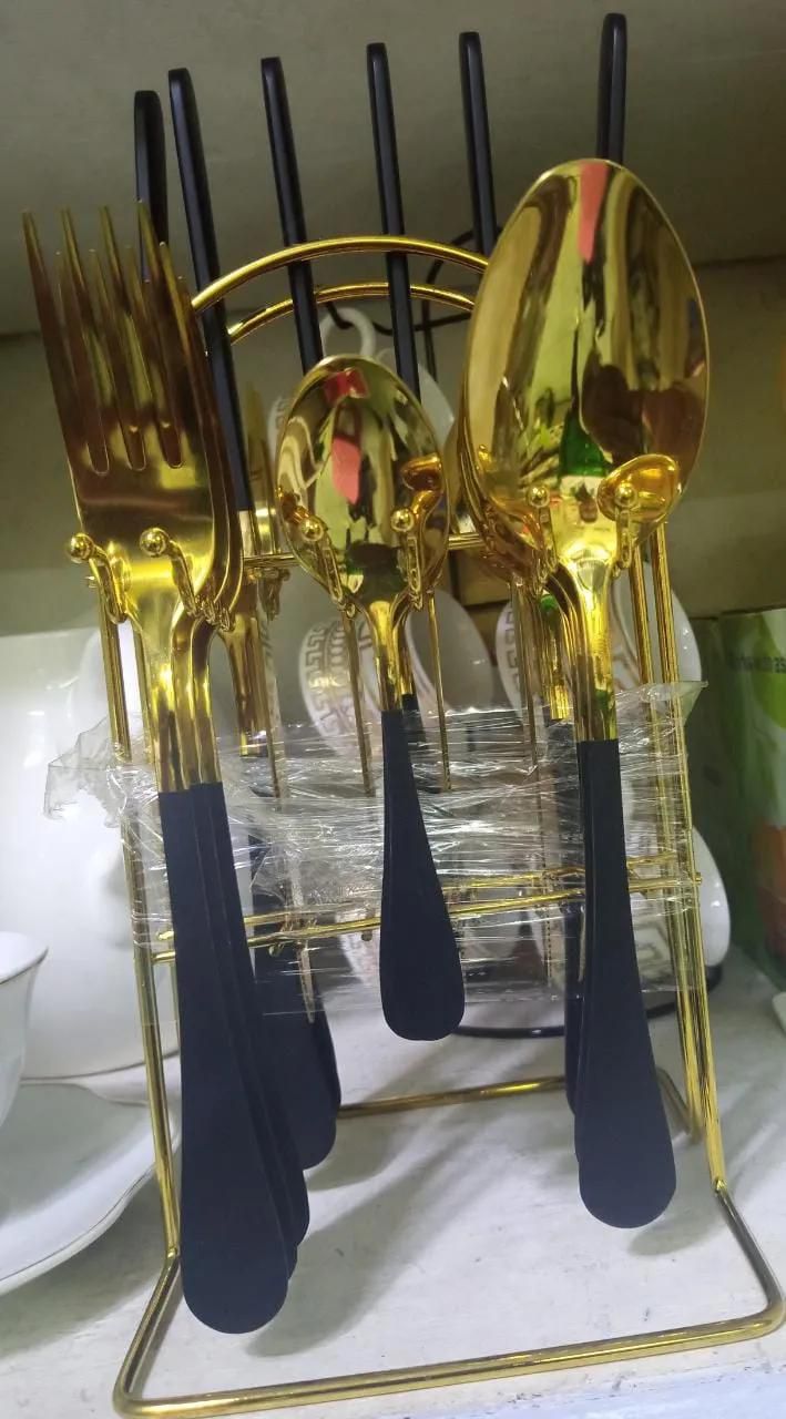 24pcs Gold curtly set with it's stand.6pcs table spoons,6pcs butter knifes,6pcs tea spoons &6pcs forks.