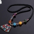 Necklace of large colored beads contain stone overhangs, most recently in the Indian style