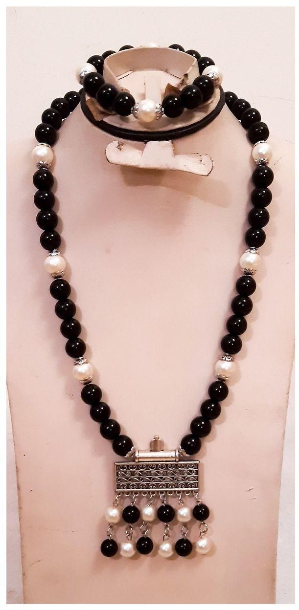 A Beautiful Necklace And Bracelet Of Off White And Black Beads