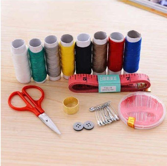 A Box Of Multi-colored Thread Spools + Sewing Needles, Scissors, And Sewing Supplies