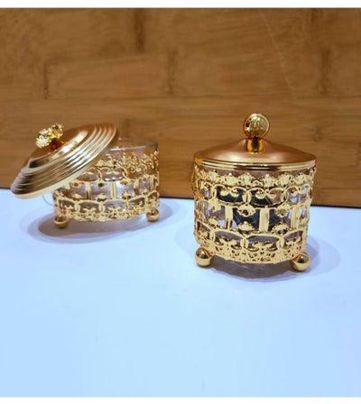 A set of two golden incense boxes with a golden lid with a royal design