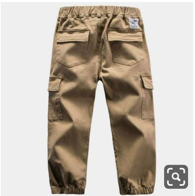 Fashion kids trousers cargo pants with side pockets and a waist band.