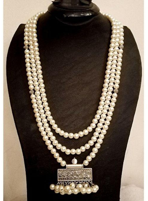 A Beautiful Layered Necklace Of Off White Beads With Pendant
