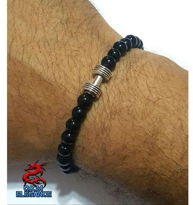 Black beads bracelet with a dangling metal bead of Elegance.O.K.M