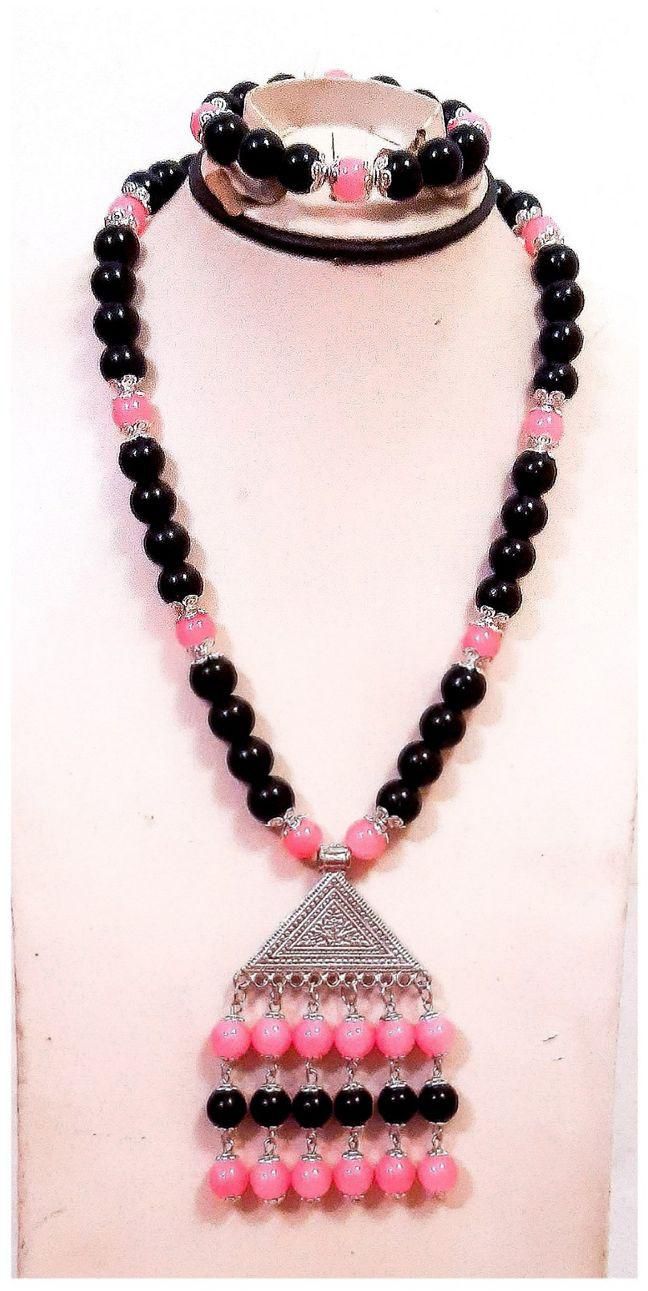 A Beautiful Necklace And Bracelet Of Black And Pink Beads