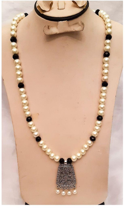 A Beautiful Necklace Of Off White And Black Beads With Pendant