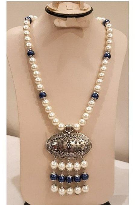 A Beautiful Necklace Of Off White And Blue Beads With Pendant